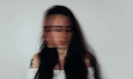 a blurry photo of a woman with glasses