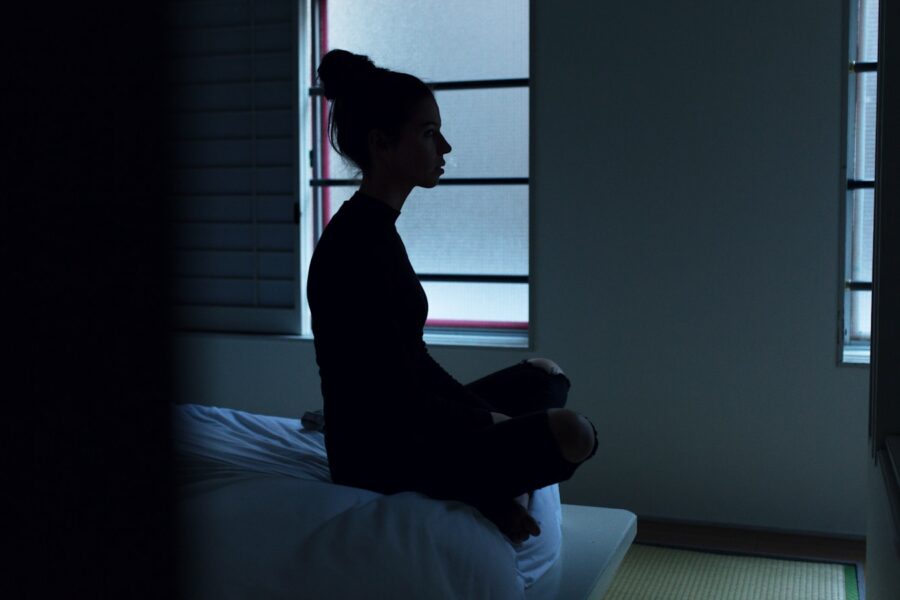 woman sitting on bed