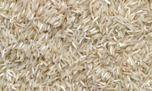 white rice grains on brown wooden table