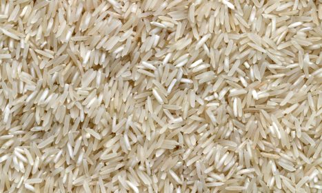 white rice grains on brown wooden table
