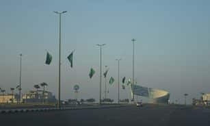 A view of a street with a lot of green flags
