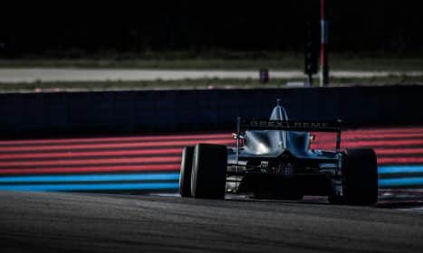red and black f 1 race car on track during daytime