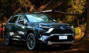 a black toyota rav parked in the woods