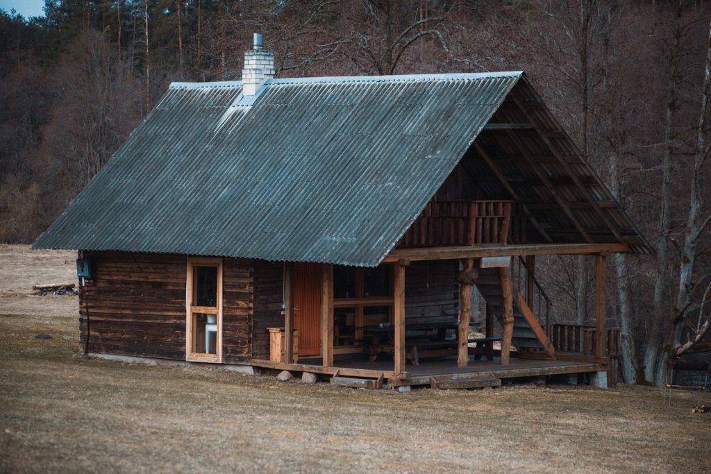 brown wooden house near trees during daytime