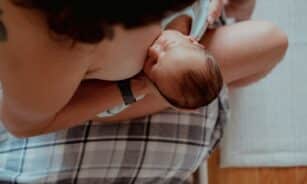 a woman holding a baby in her lap