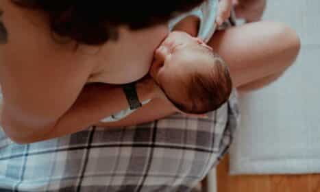 a woman holding a baby in her lap