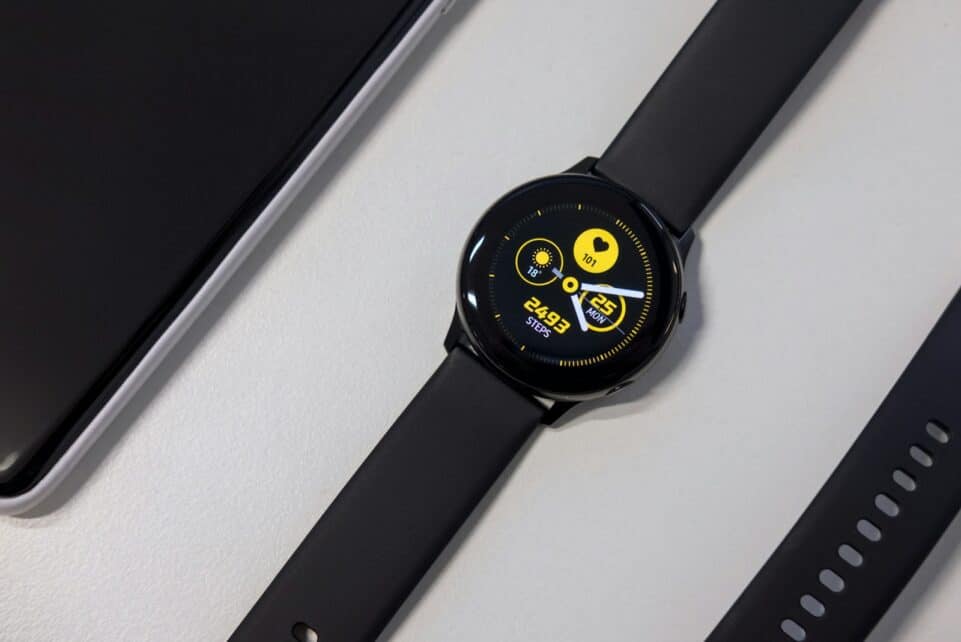 turned-on black smartwatch on white surface