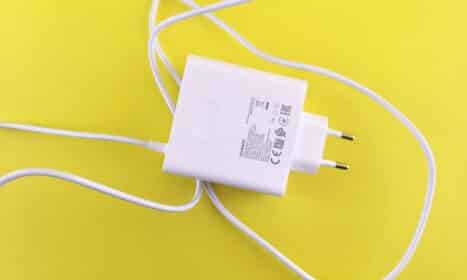 A white cord plugged into a wall charger