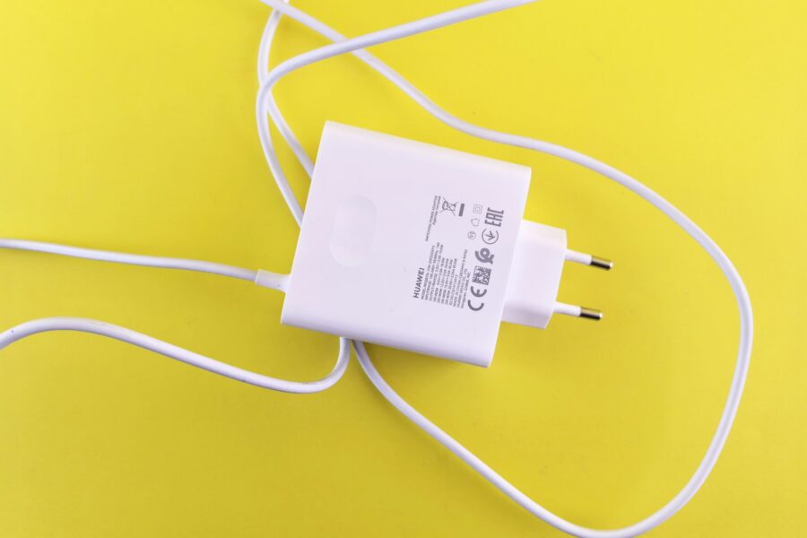 A white cord plugged into a wall charger