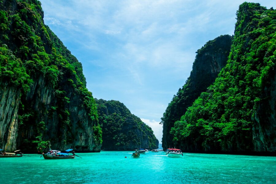 boats on sea near mountain during daytime