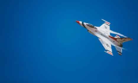 white and red jet plane hovering on sky at daytime