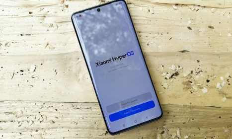 A cell phone sitting on top of a wooden table