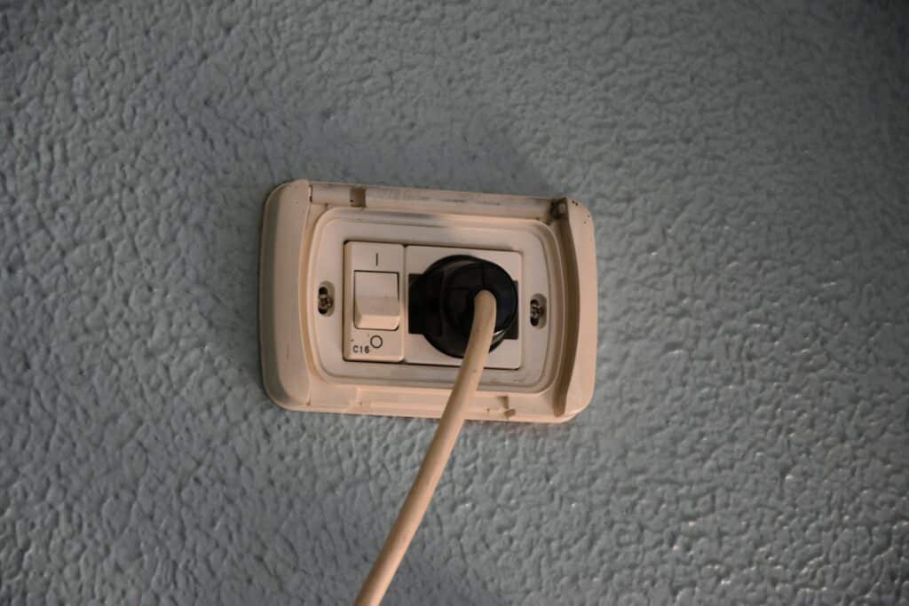 a light switch with a wooden stick sticking out of it