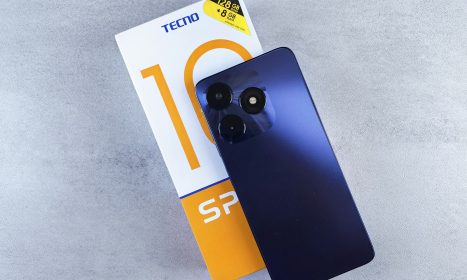 a blue cell phone sitting on top of a box