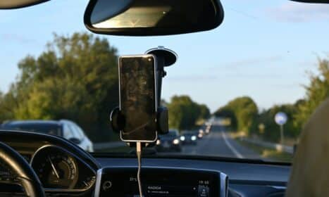 a car dashboard with a cell phone attached to it