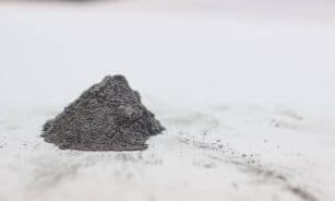 a pile of dirt sitting on top of a white surface