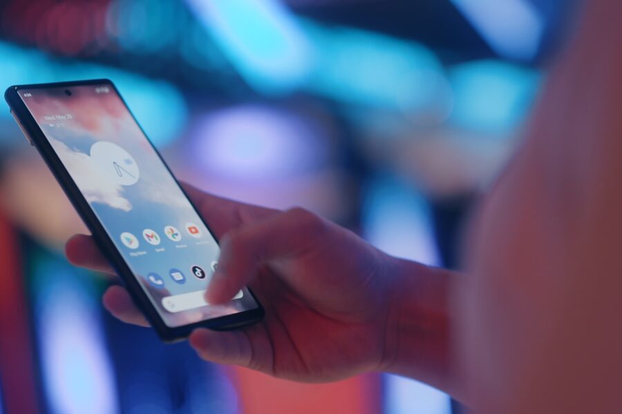 a person holding a cell phone in their hand