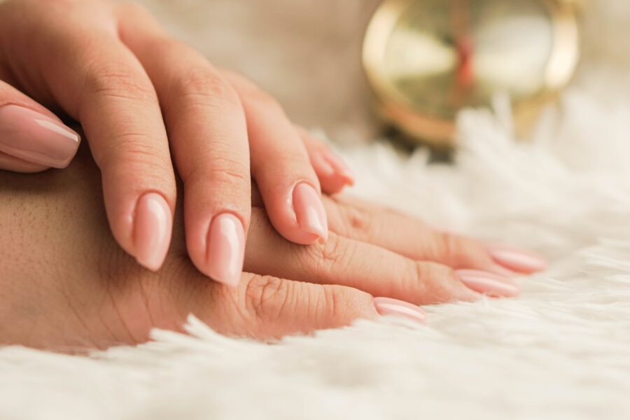 persons hand on white textile