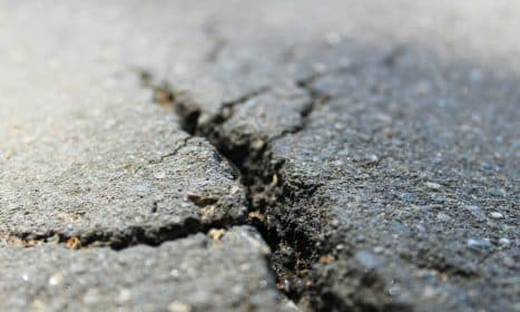 a crack in the asphalt of a road