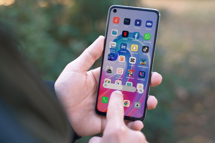 a person holding a cell phone in their hand