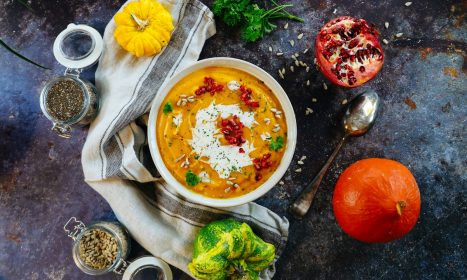 soup with sliced lemon on white ceramic bowl