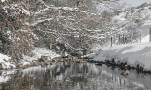 a lake surrounded by snow