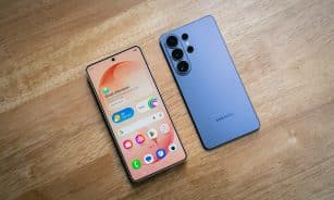 Two smartphones displayed on a wooden surface.