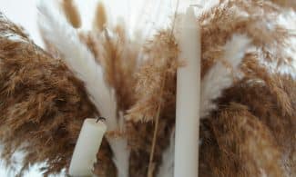 a couple of white candles sitting next to each other