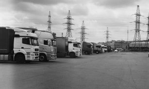 a black and white photo of trucks parked in a lot