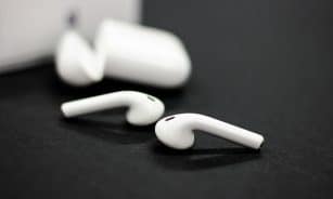 a pair of ear buds sitting on top of a table