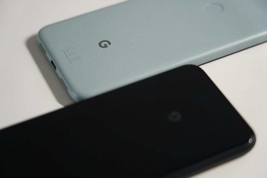 a close up of two cell phones on a table