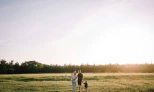man and woman walking on green grass field during daytime