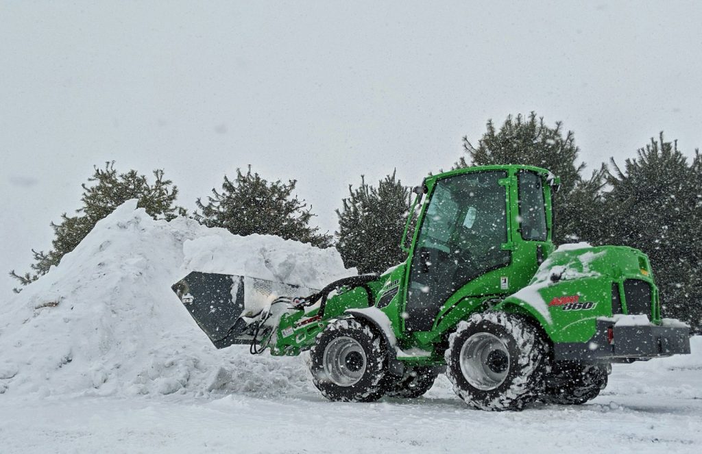 green and black atv on snow covered ground