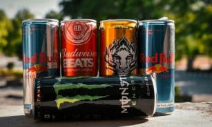 a group of four cans of soda sitting next to each other