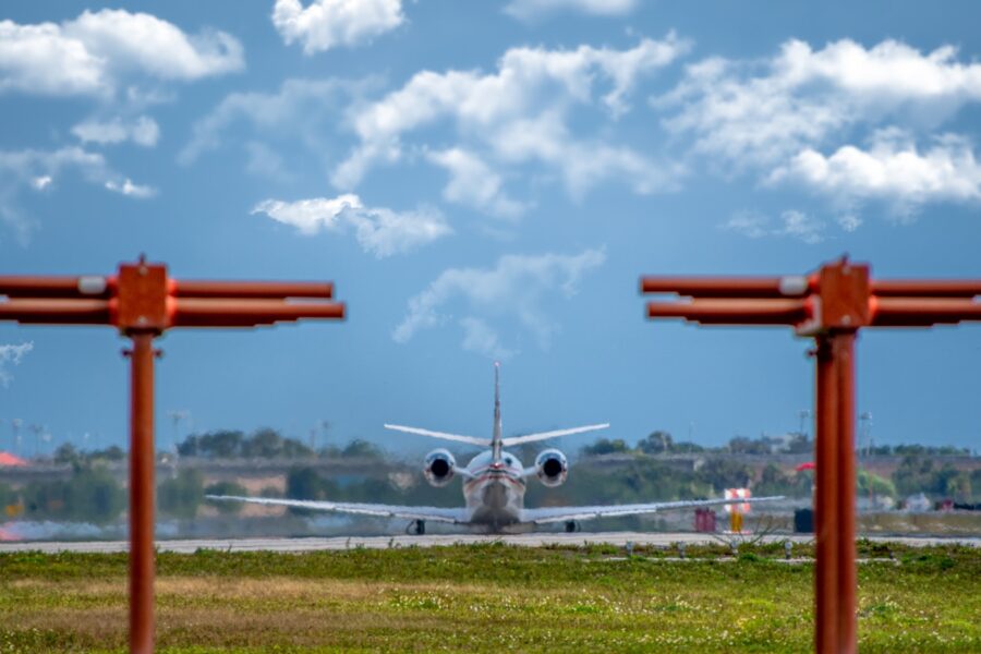 white and red airplane under blue sky during daytime