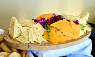 sliced cheese on brown wooden chopping board