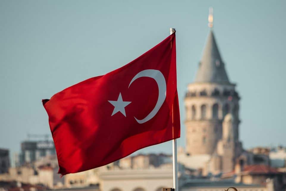 a turkey flag flying in front of a building