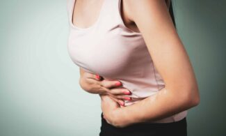 A person holding their stomach in pain.