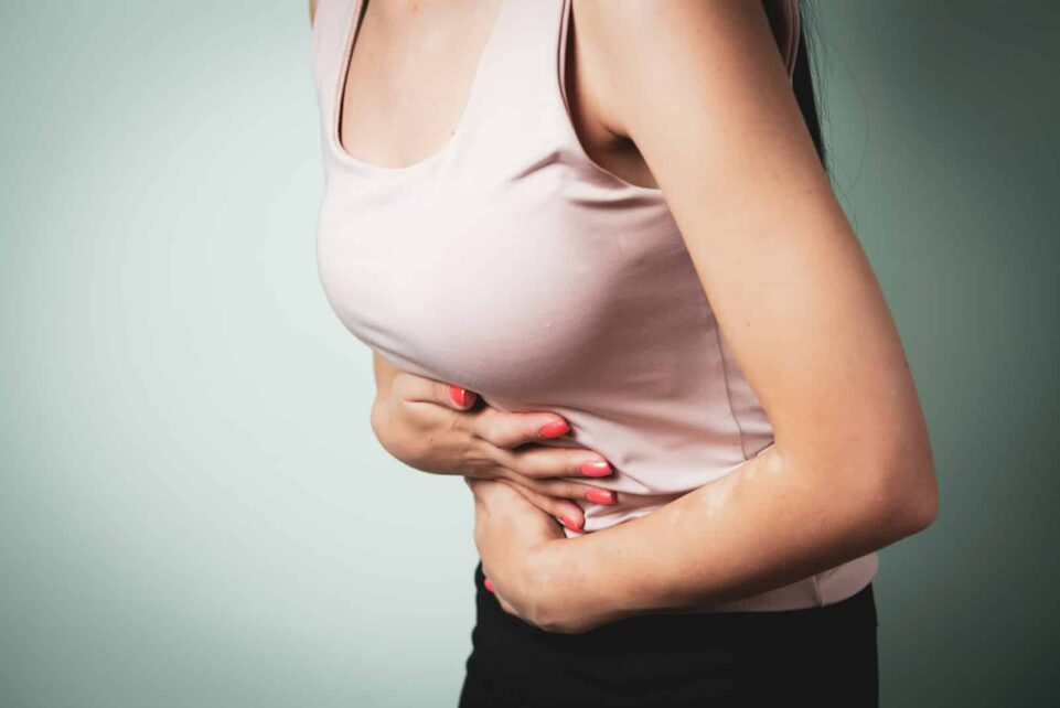 A person holding their stomach in pain.