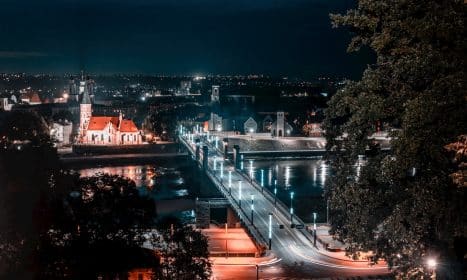 a view of a city at night from a hill