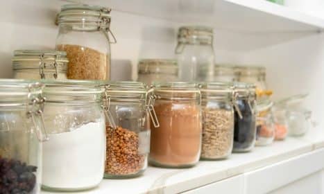 a row of jars filled with different types of food
