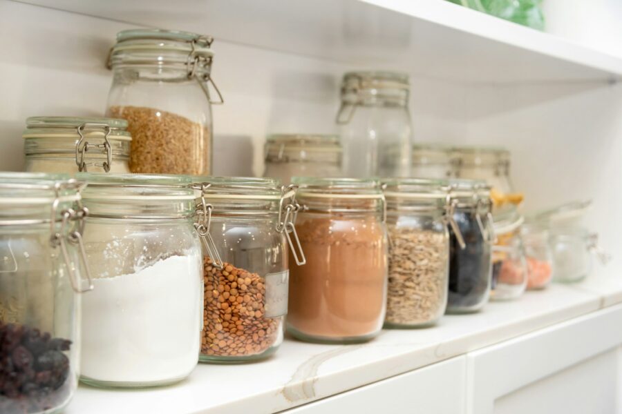 a row of jars filled with different types of food