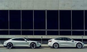 white sedan parked beside white and black building