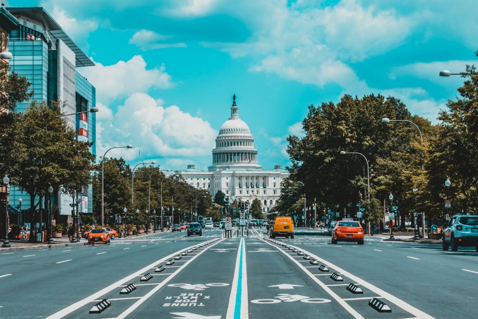 wide road with vehicle traveling with white dome building