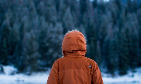 shallow focus photography of person facing trees