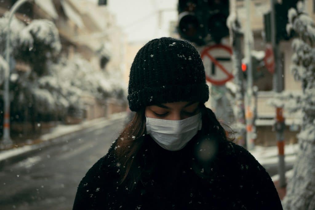 person in black knit cap and black jacket