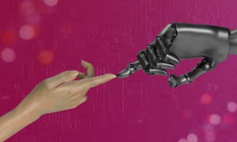 two hands touching each other in front of a pink background