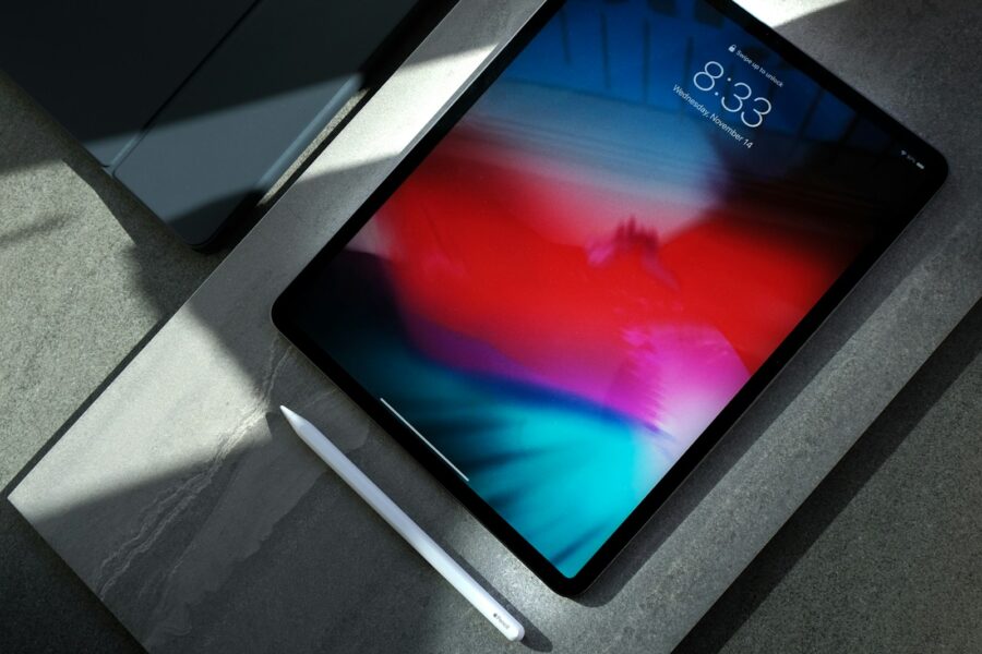 black iPad with white stylus pen