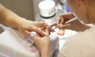 a woman getting her nails done at a nail salon