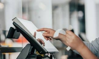 a person is using a pos machine in a store